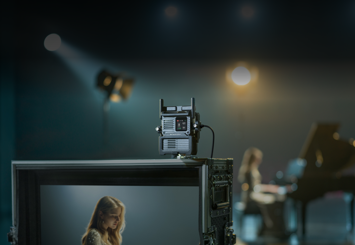 DJI SDR Transmission 2 mounted above a production monitor on a film set